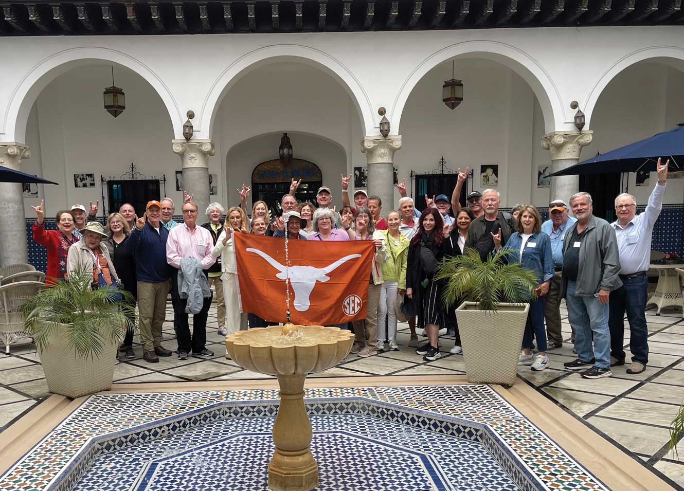 Traveling Longhorns throw their horns up in Tangier. 