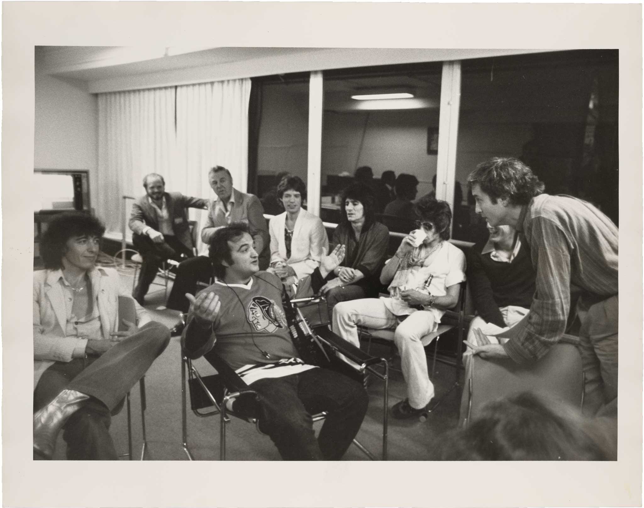 Lorne Michaels talks with John Belushi and the Rolling Stones