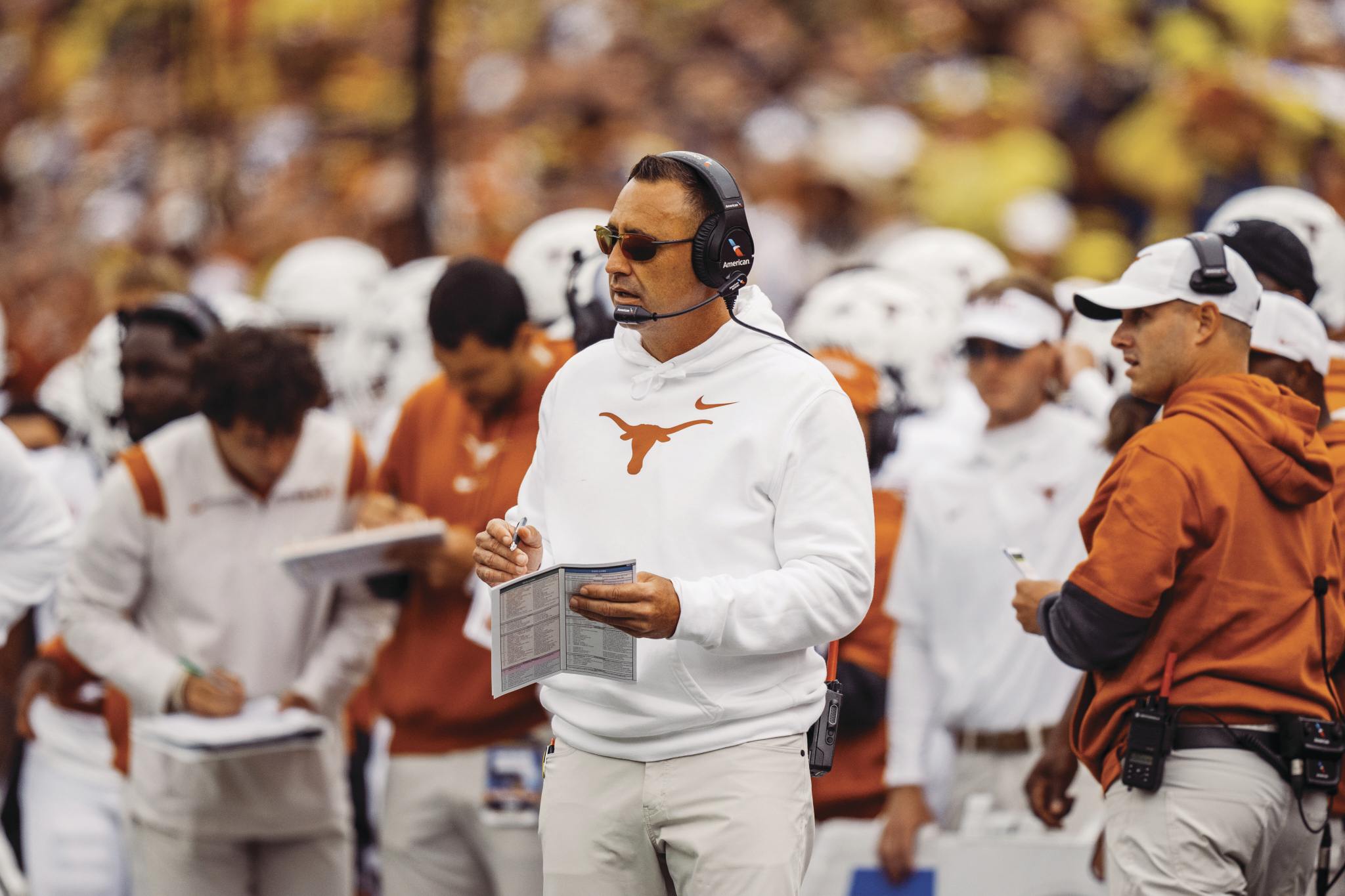 Coach Sarkisian coaches the Longhorn football team.