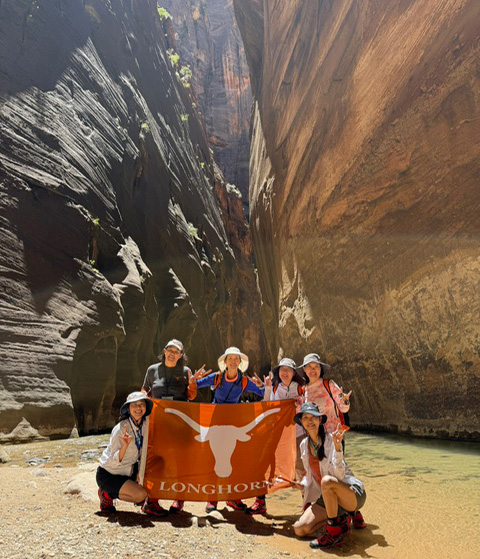 Group of UT Austin alumnae hiking the Narrows in Zion National Park.