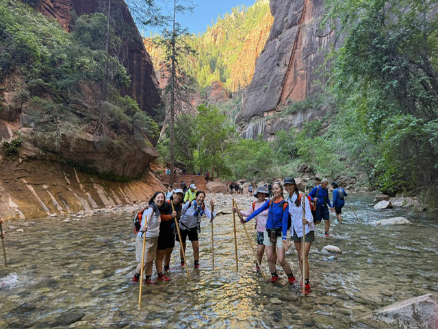 Longhorn alumnae hike the Narrows at Zion NP.