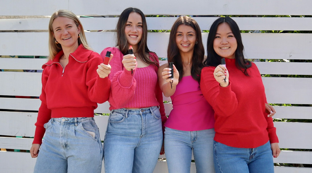 The founders of Safely each holding their award-winning pepper spray.