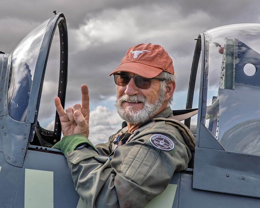 Hook em Horns in the cockpit of an airplane.
