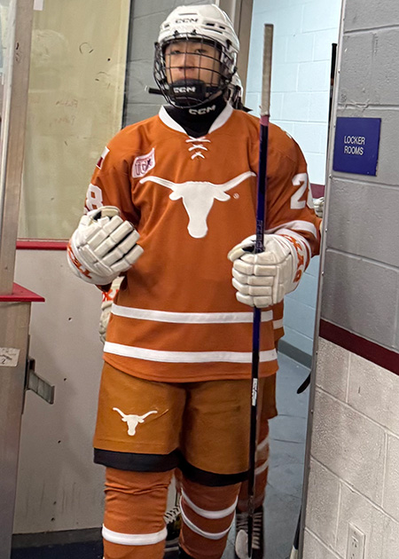 Texas Longhorns hockey player in burnt orange uniform.