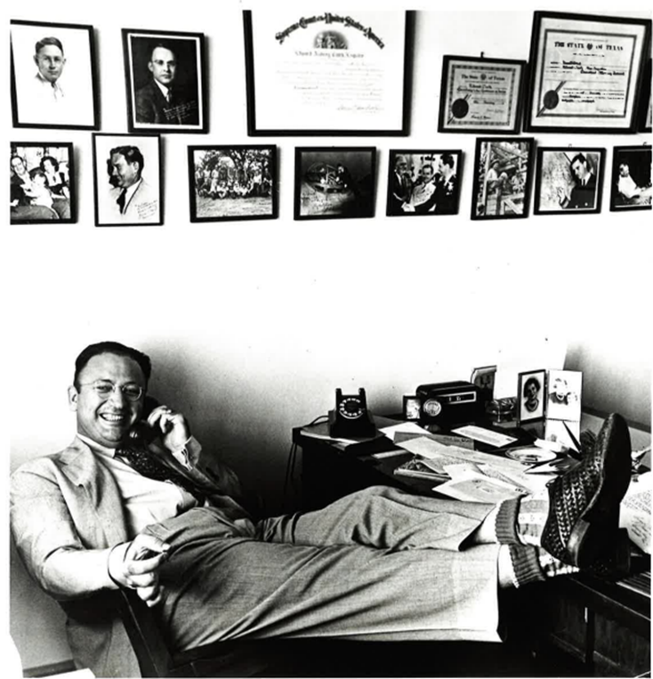 Edward A. Clark with his feet up at his desk.