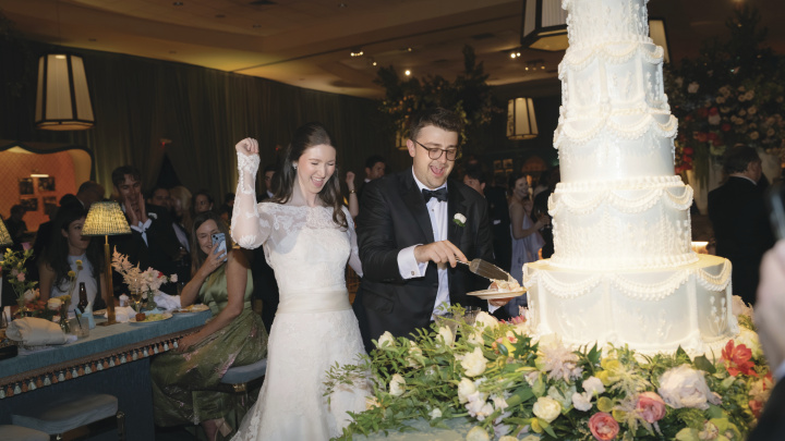 A bride and groom cuts the cake.