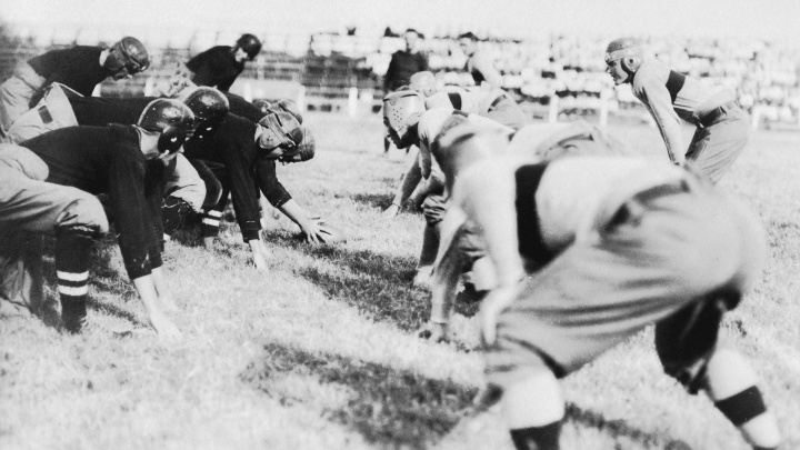 An archival photo of football players at the line, 1914.