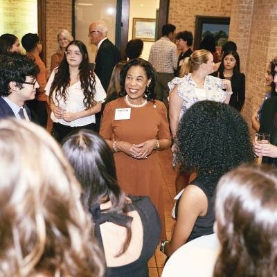 Kea surrounded by scholarship students at the Etter-Harbin Alumni Center.