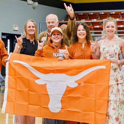 Texas Alumni in Mills County hold burnt orange UT Flag
