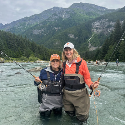 Two Longhorn alumnae fishing in Alaska river.