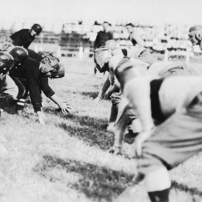 An archival photo of football players at the line, 1914.