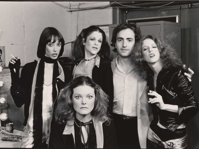 Lorne Michaels standing with the female cast of SNL. 
