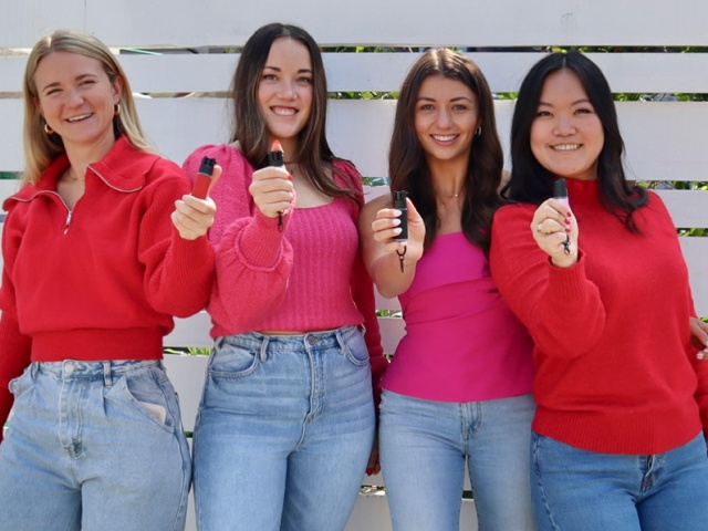 The founders of Safely each holding their award-winning pepper spray.