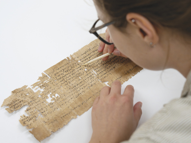 Rachel Mochon conserving an Egyptian papyrus fragment.