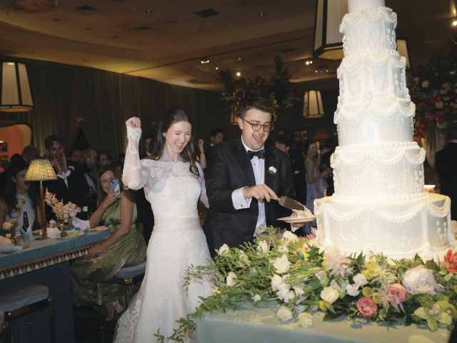 A bride and groom cuts the cake.
