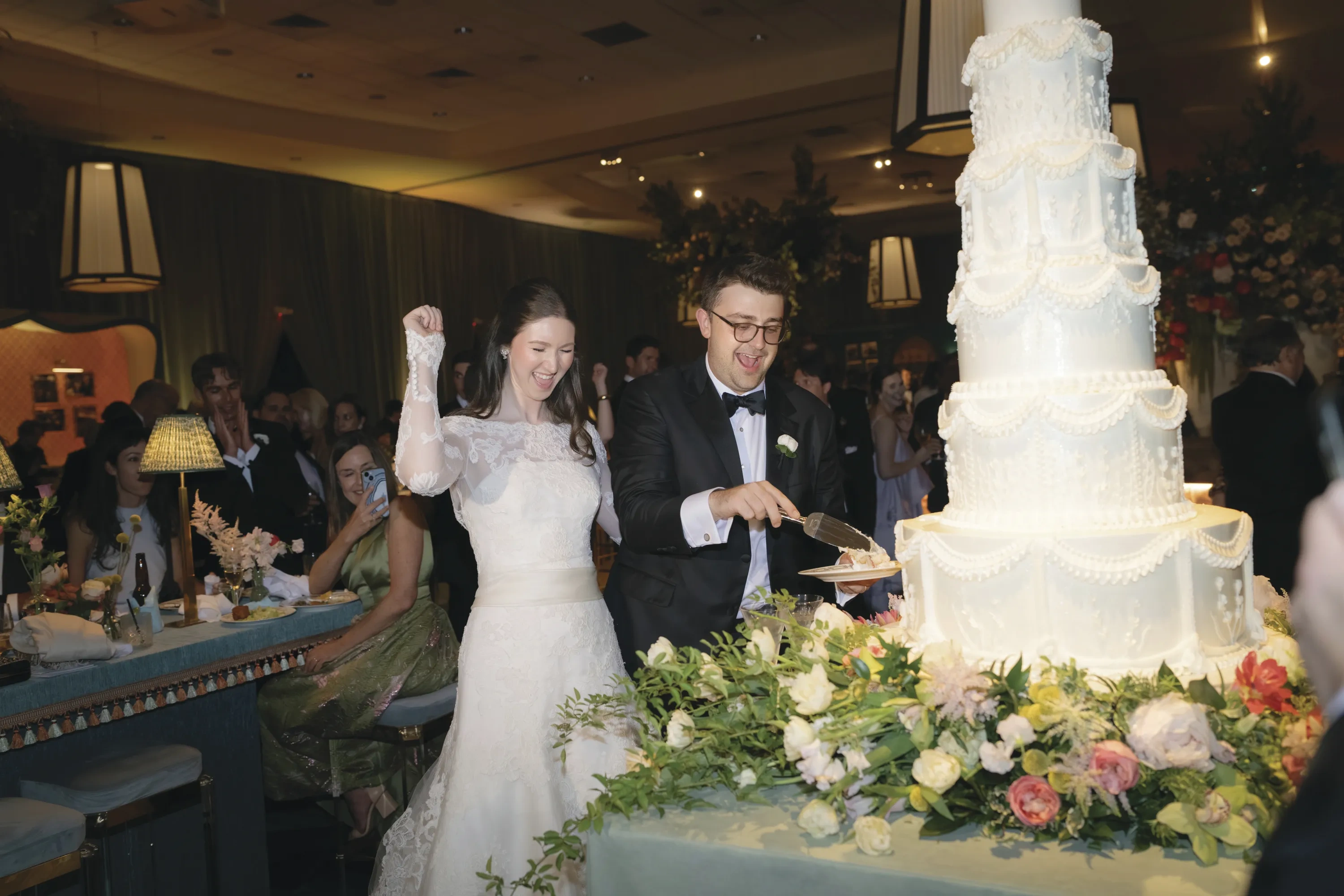 A bride and groom cuts the cake.