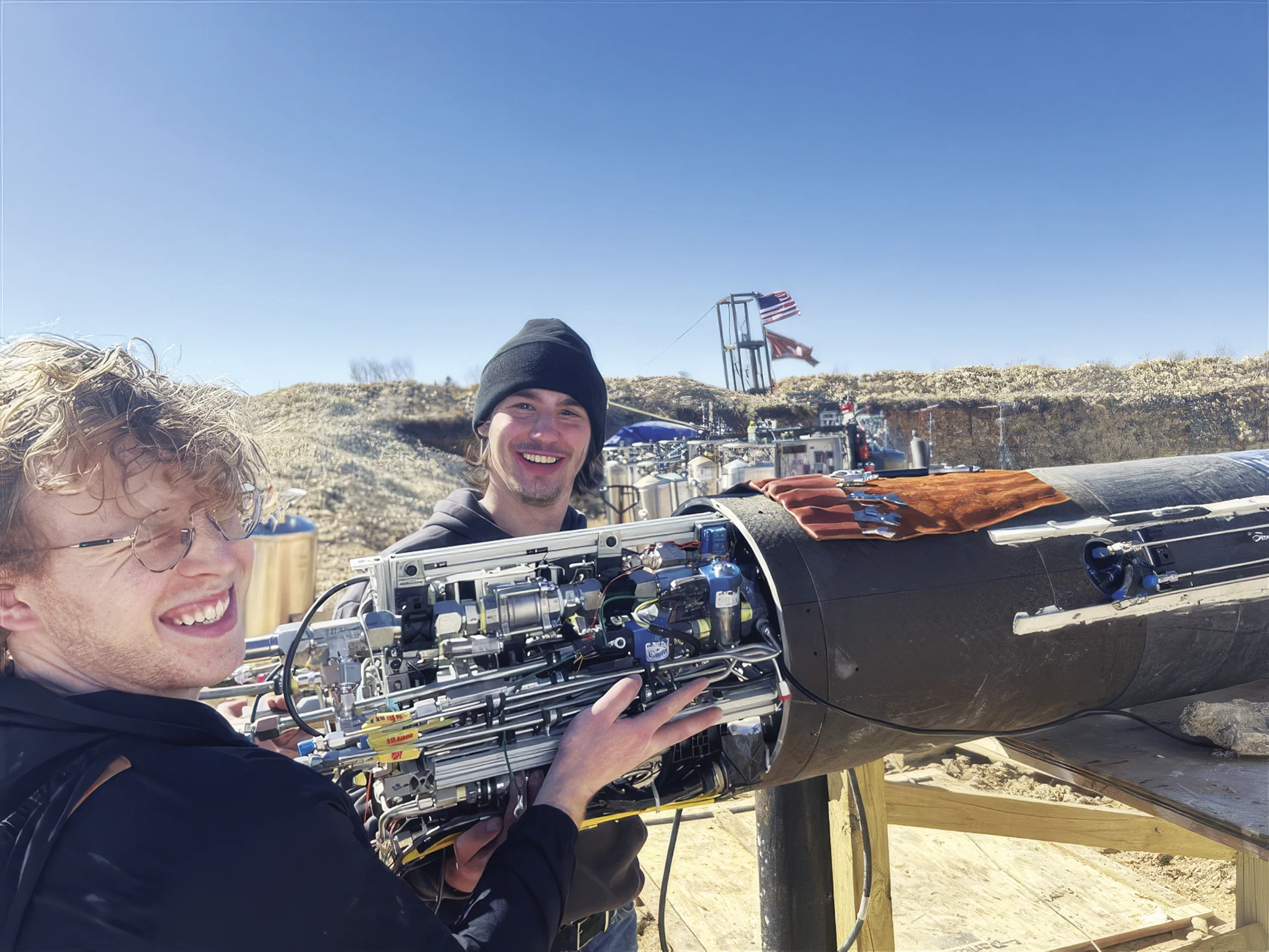 Students work on the rocket in the field.