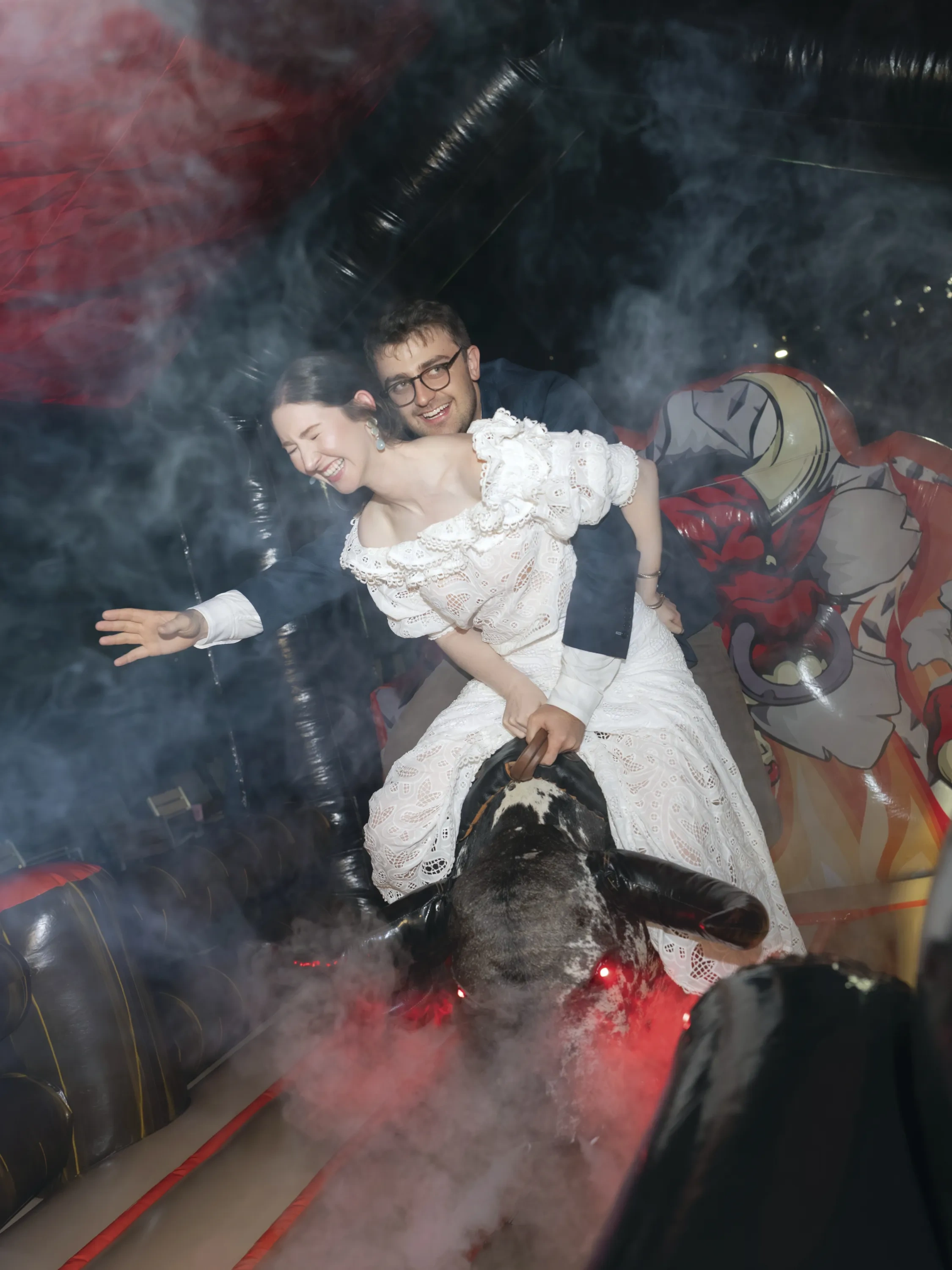 A couple on a mechanical bull.