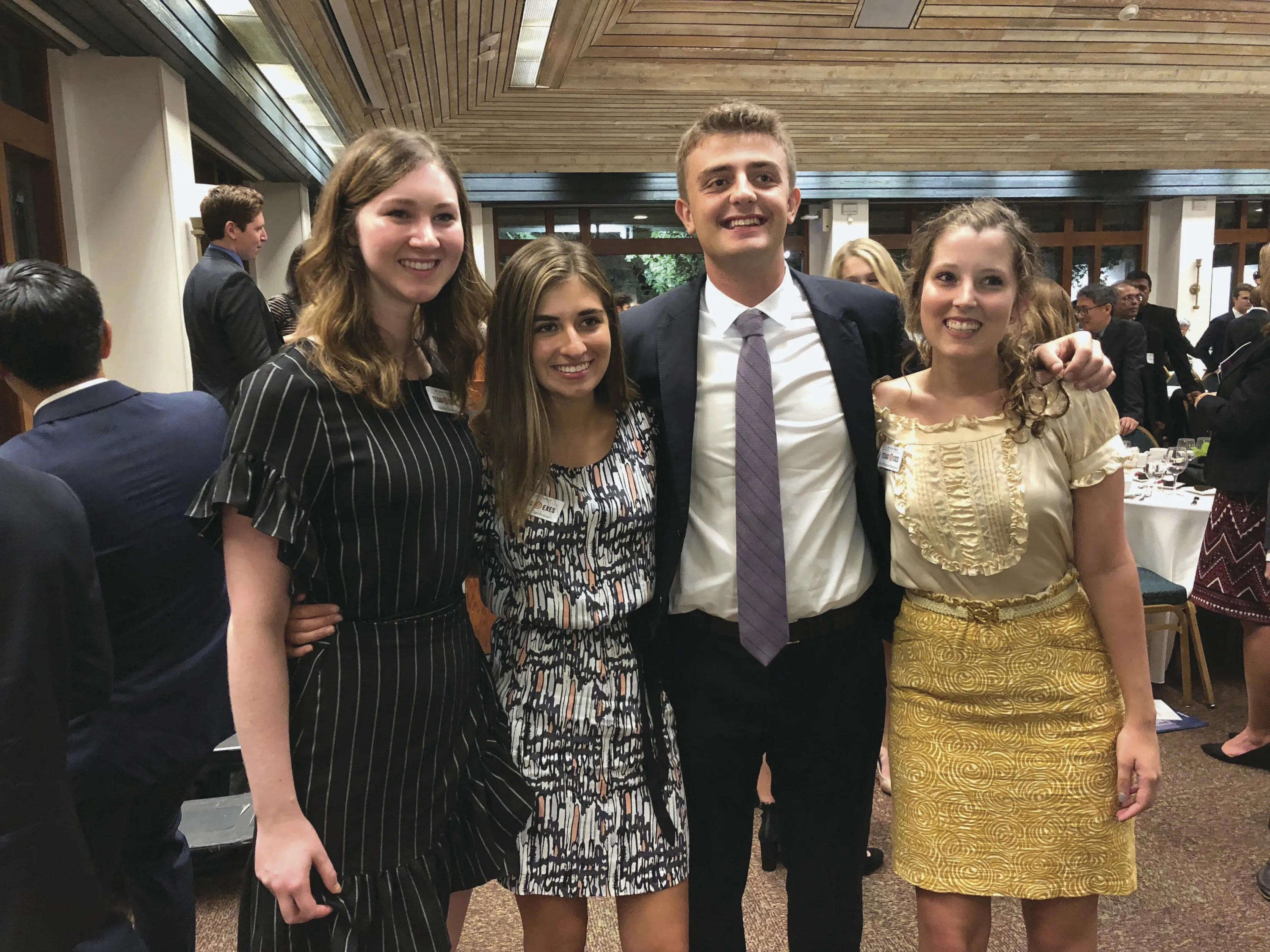 Four college students pose together in formal gear.