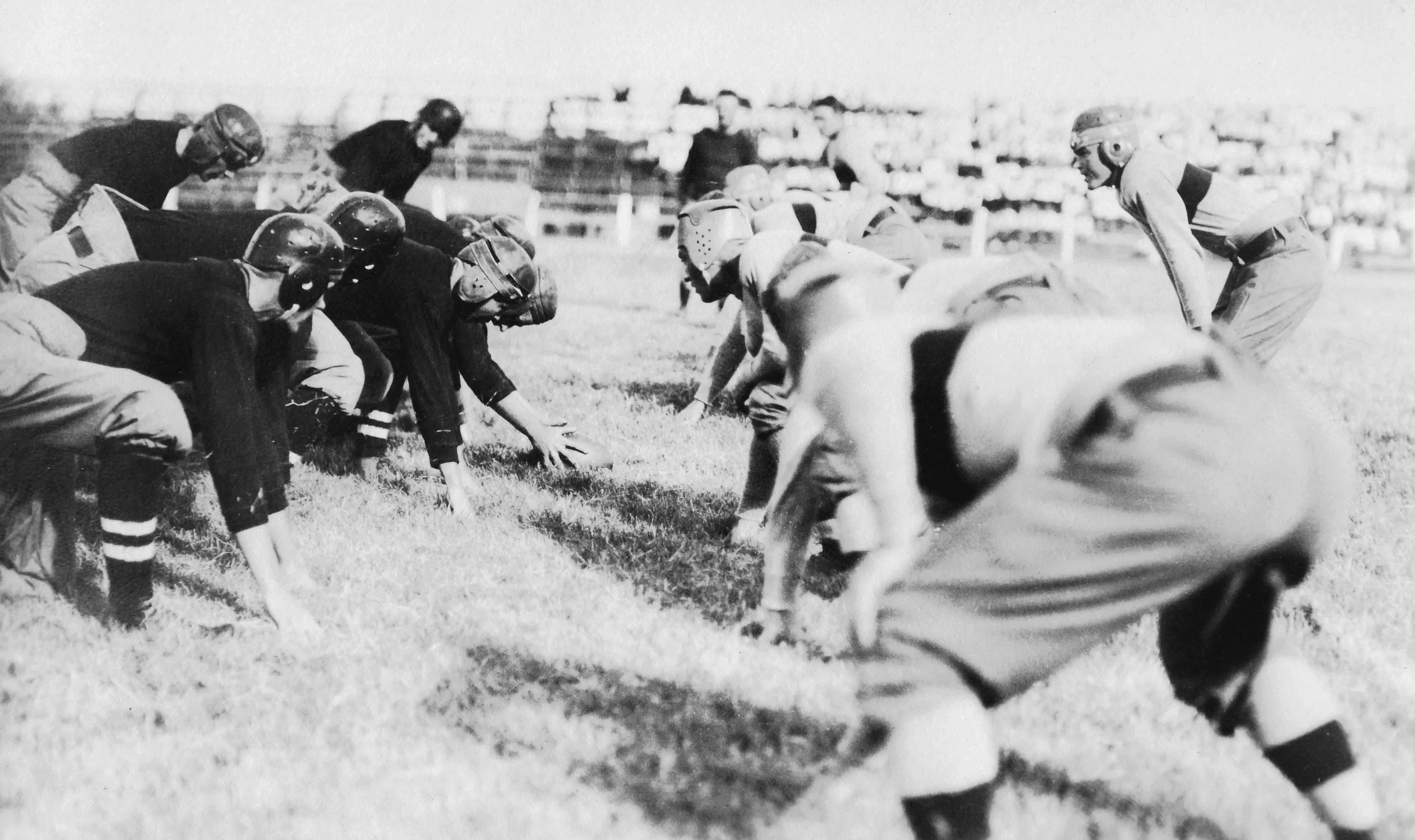 An archival photo of football players at the line, 1914.