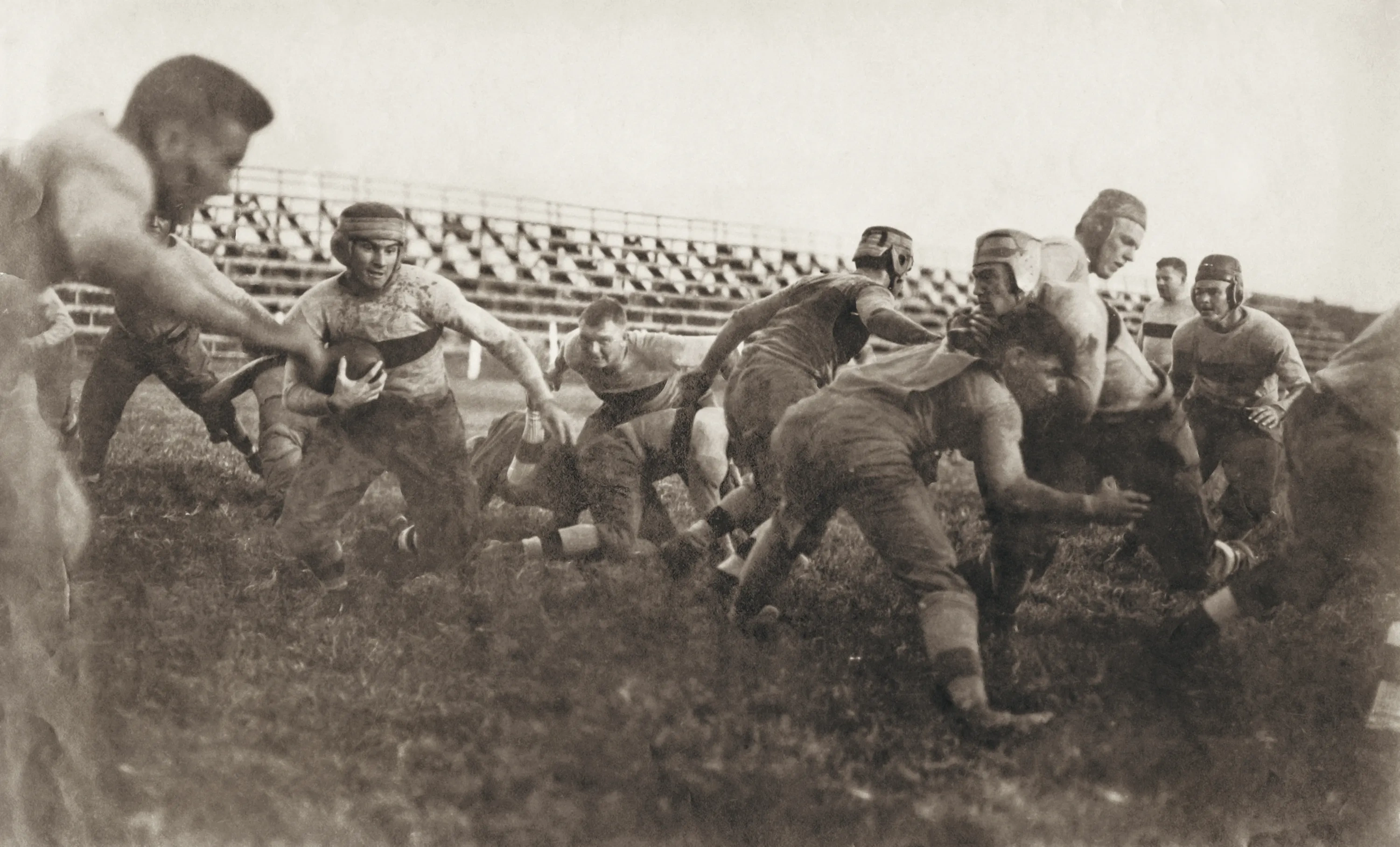 An archival photo of a football scrimmage, 1914.
