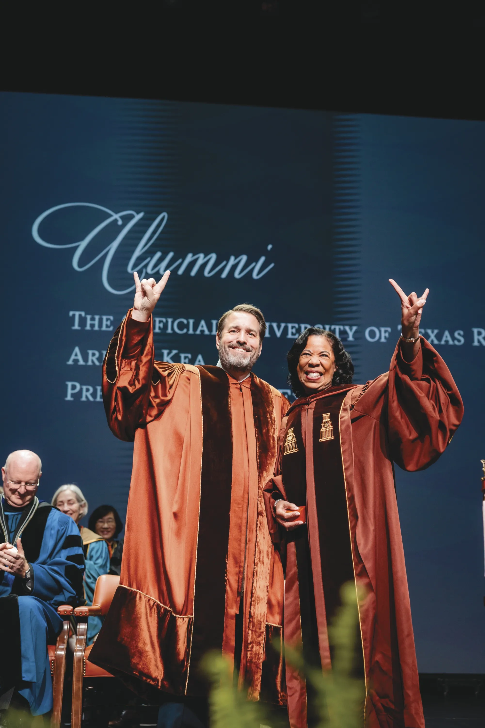 President Jim Davis and Arleas Upton Kea in burnt-orange investiture gowns.
